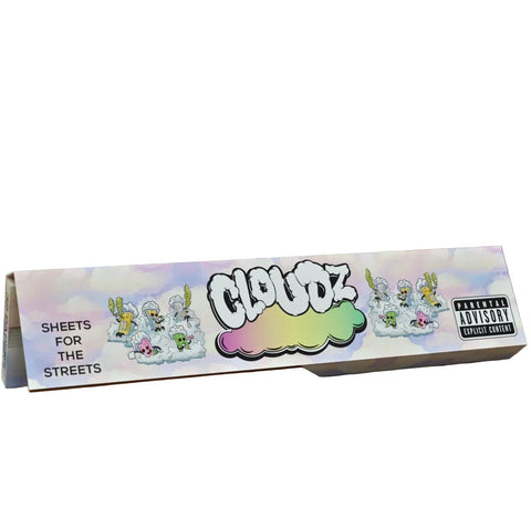 A long rectangular box of Cloudz brand rolling papers on a plain white background. The packaging features a pastel sky design with cartoon rabbits on clouds, the 'CLOUDZ' logo in white with a rainbow cloud base, and a Parental Advisory label on the right.